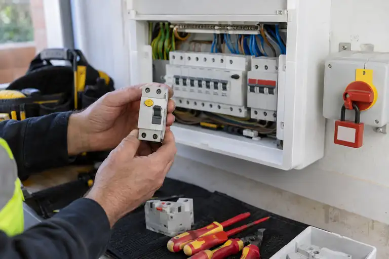 RCD replacement: a professional electrician assessing or carrying out the electrical work.